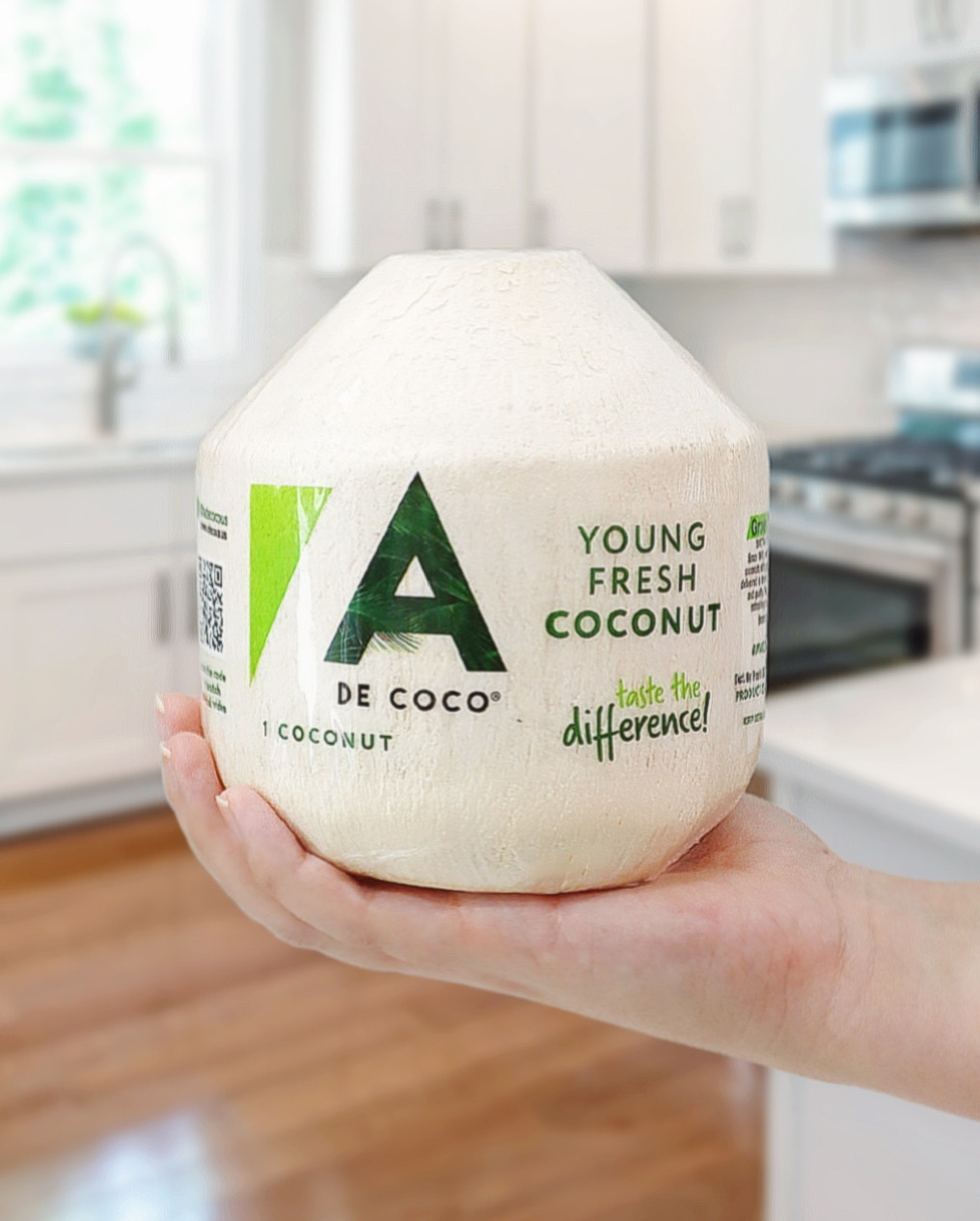 An A de Coco Young Fresh Coconut held in a kitchen